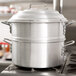 A Town aluminum steamer set with a large silver pot.