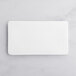 A white rectangular plate on a marble surface.